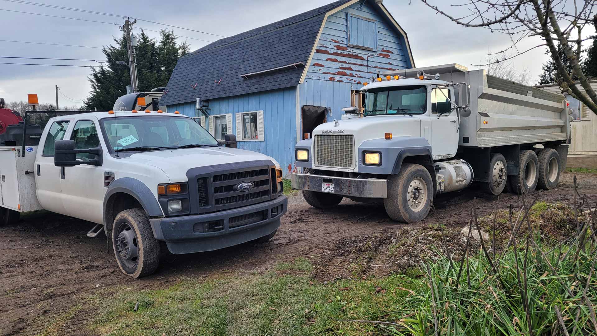 Two Salish Excavation and Trucking LLC trucks parked in lot