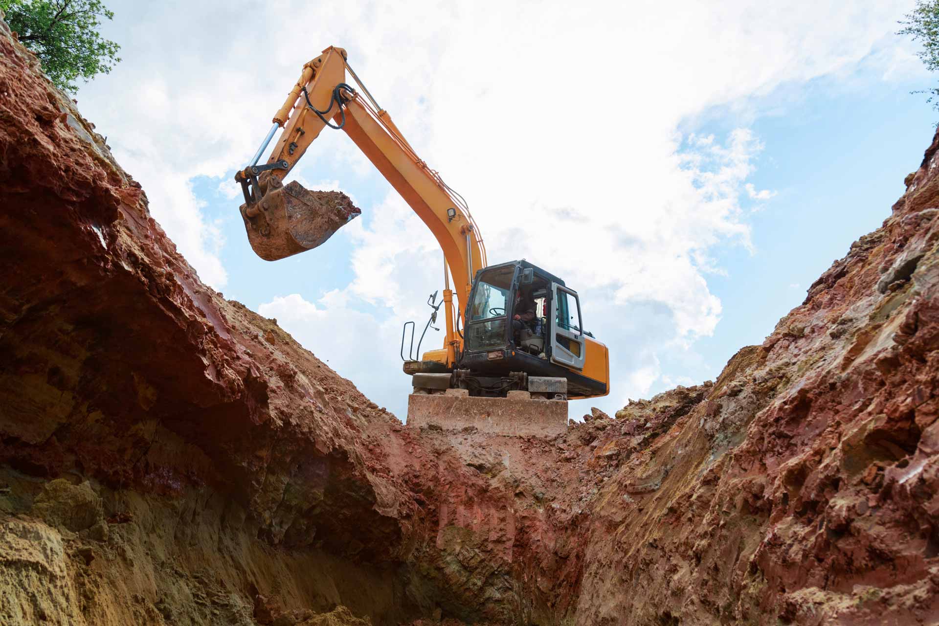 Low angle-shot of excavator digging a hole