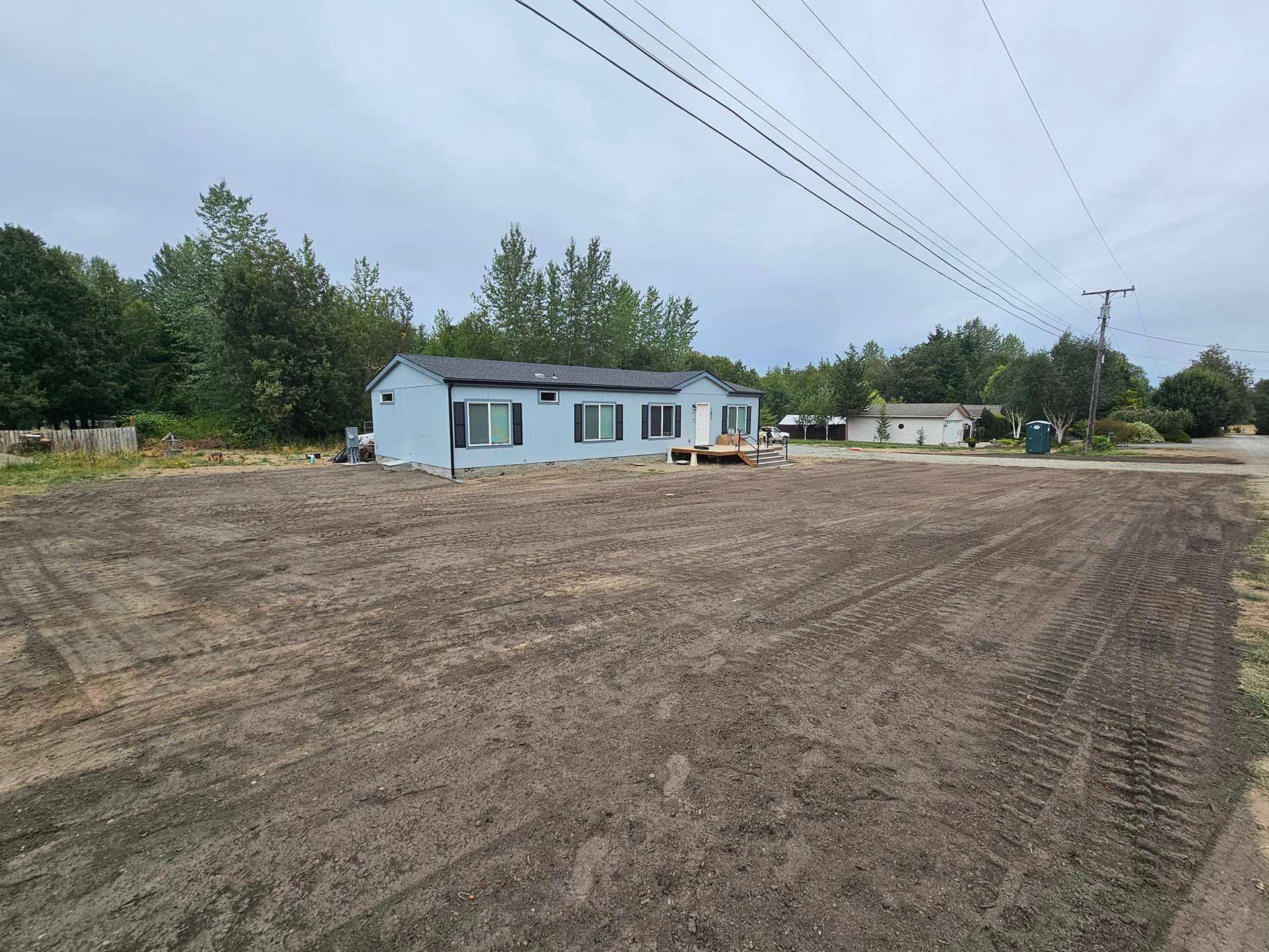 Newly cleared lot with a blue trailer