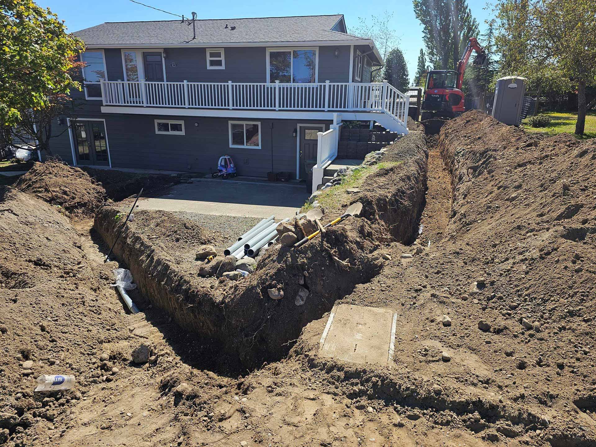 Large trench dug in residential backyard for utility installation