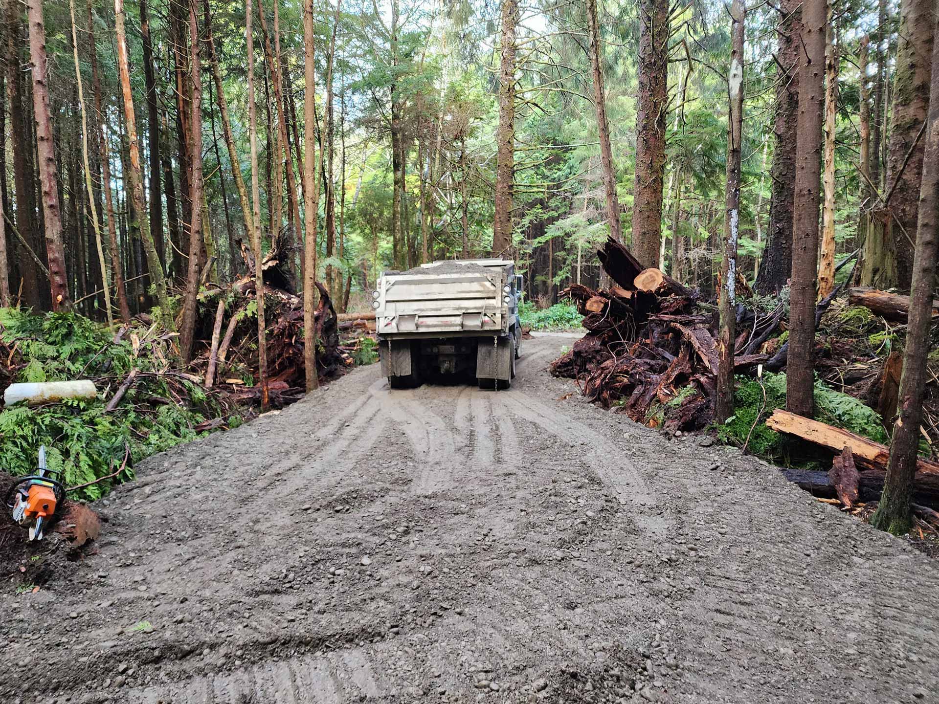 Truck driving away after dumping load of gravel