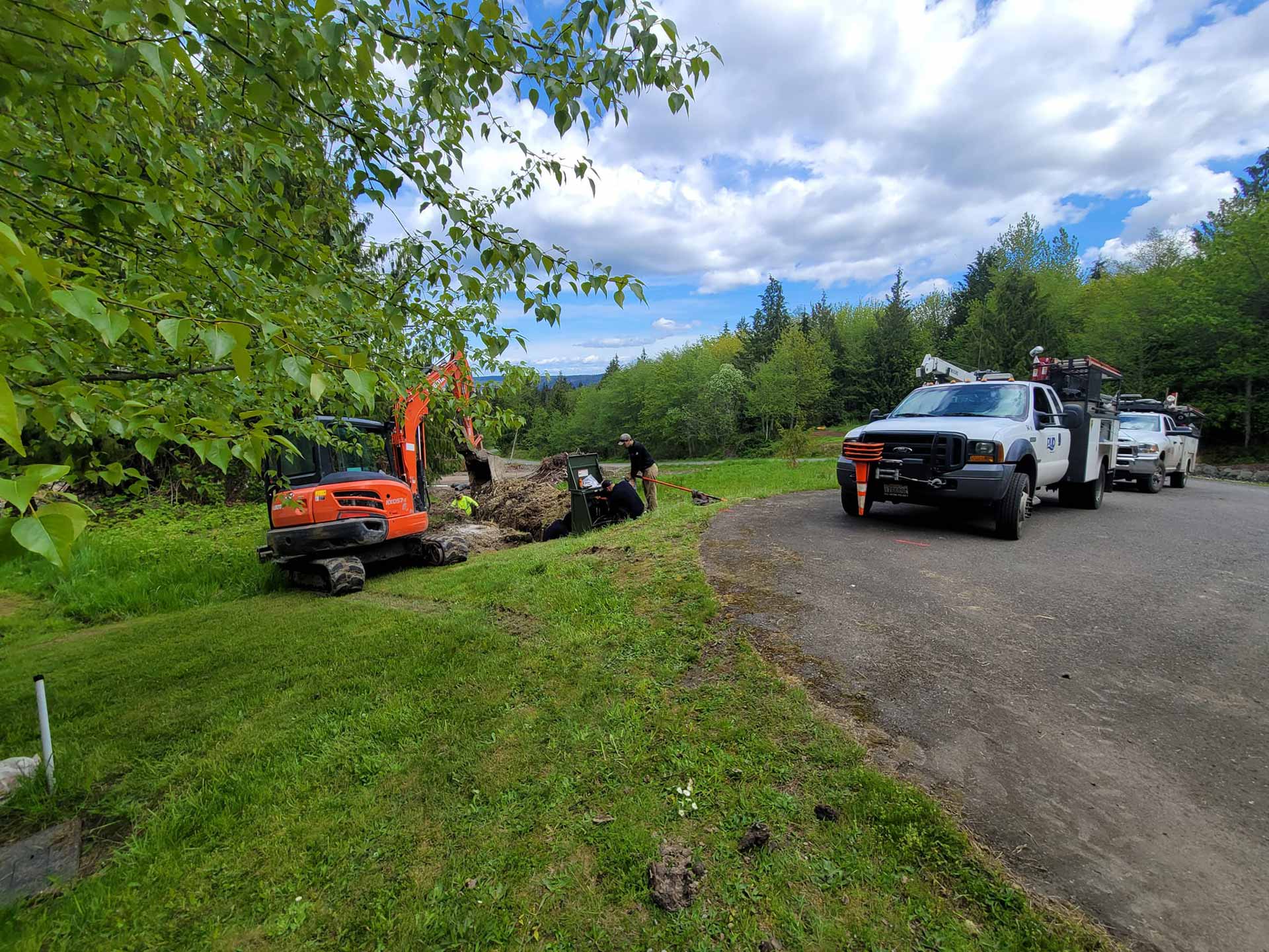 Trucks from Salish Excavation and Trucking LLC parked at a job site